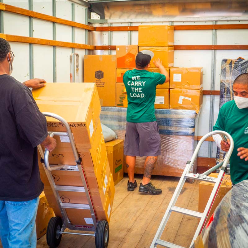 Image: Stonebriar Moving crew working together to load boxes.